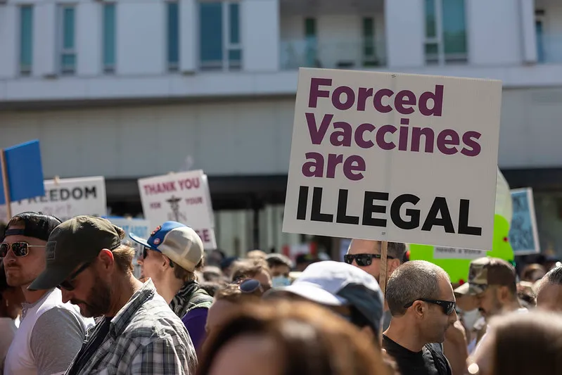 Sign at protest saying "Forced vaccines are illegal"