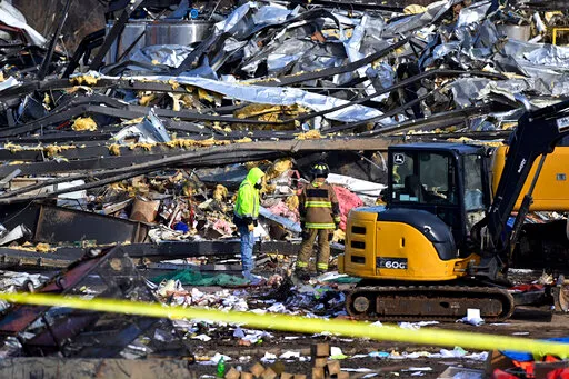 Response workers dig through the rubble of the candle factory in Mayfield, Ky., Saturday, Dec. 11, 2021.